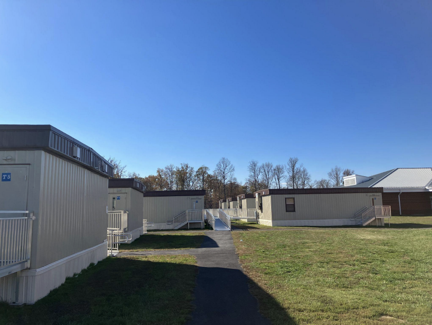 a bunch of trailers on school grounds in a field of green