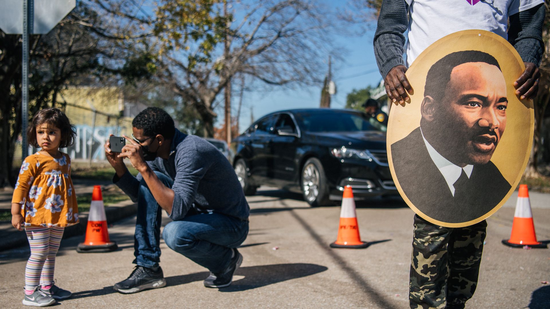 A man takes a picture of his child during the 28th Annual Martin Luther King Jr. Grande Parade on January 17, 2022 in Houston, Texas