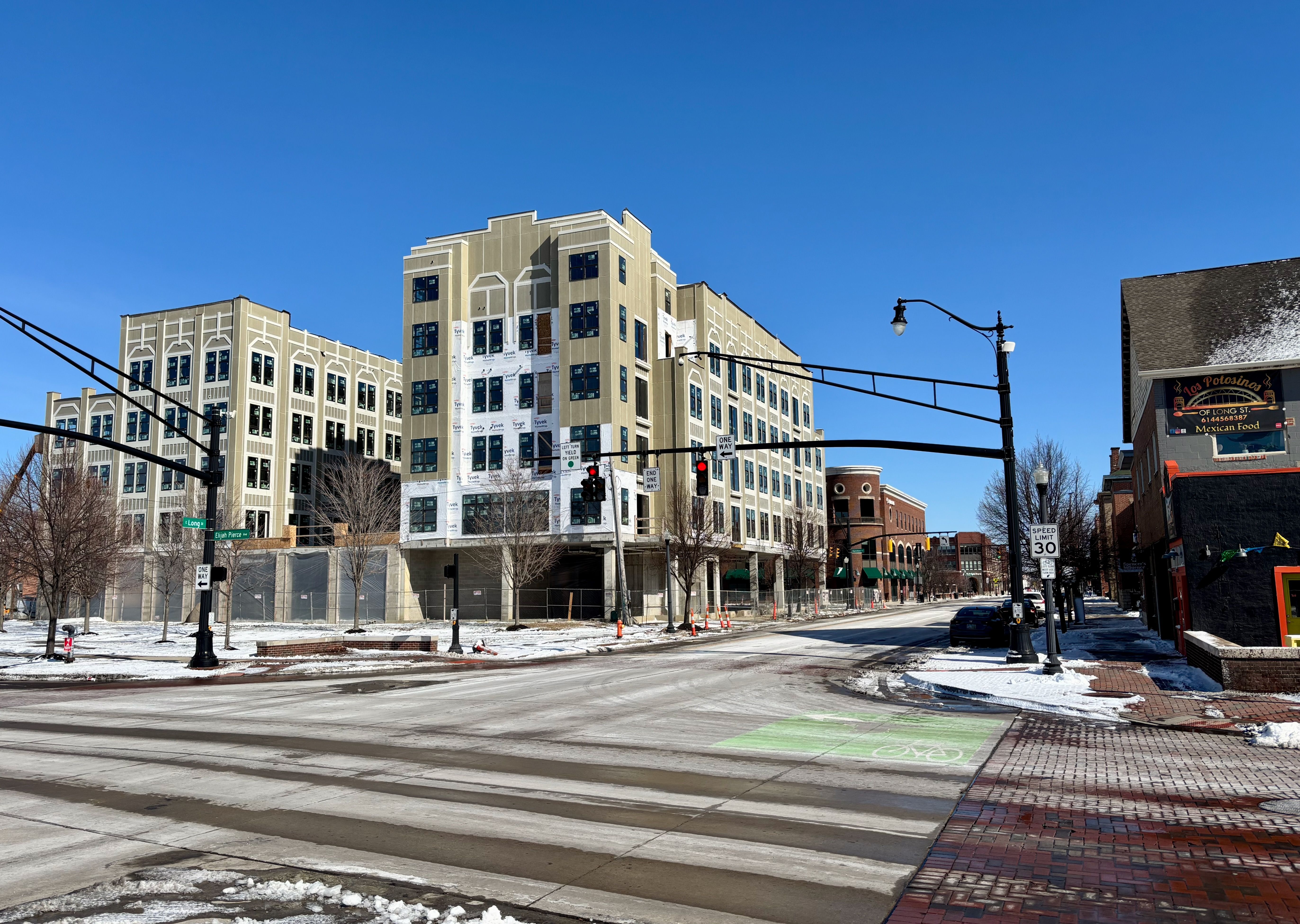 The entrance to the King Lincoln-Bronzeville neighborhood in present day, with a large five-story apartment complex rising up at the intersection of Long Street and Elijah Pierce Avenue