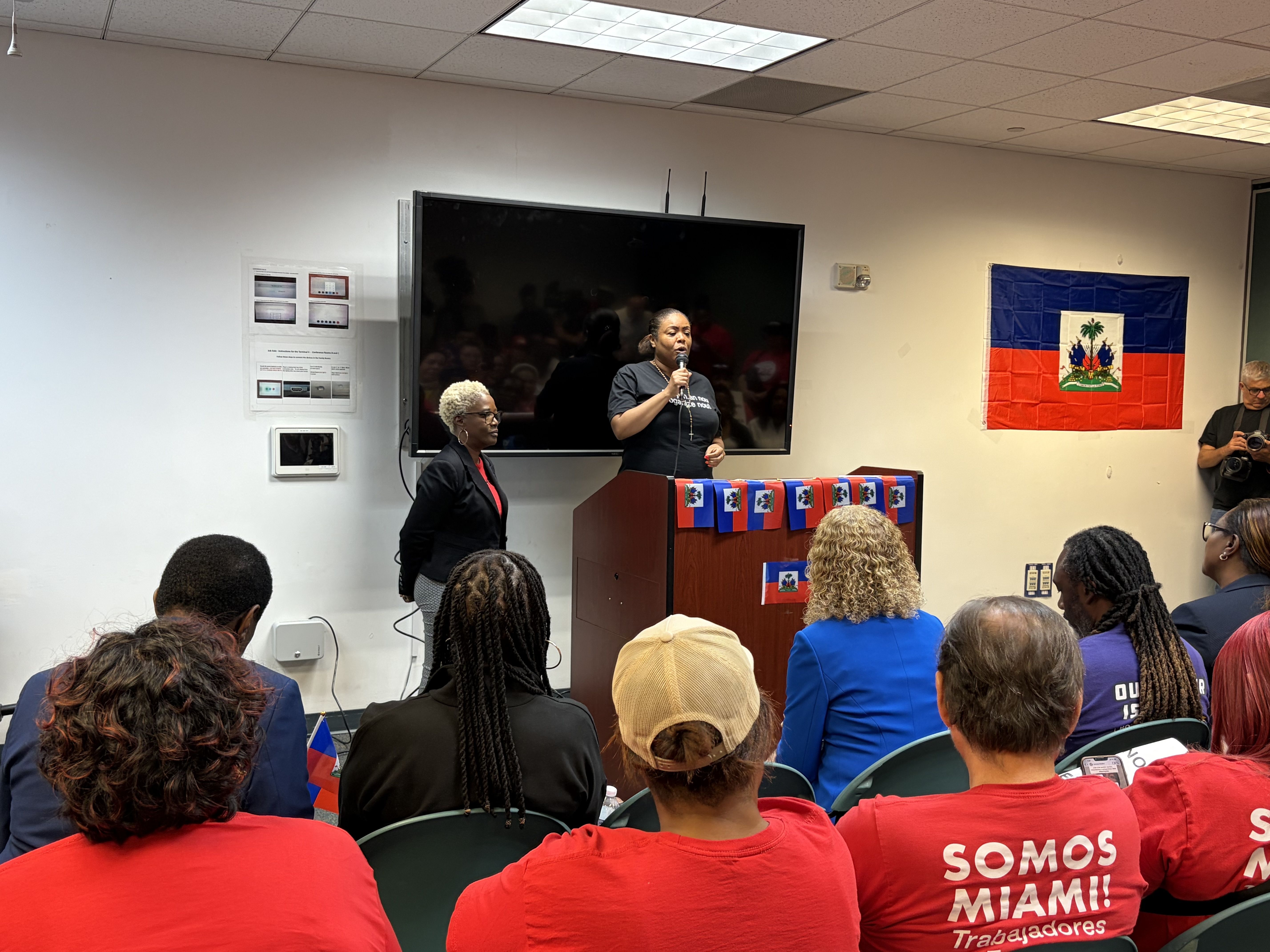 Farah Larrieux speaks at a TPS rally at the Fort Lauderdale-Hollywood International Airport.