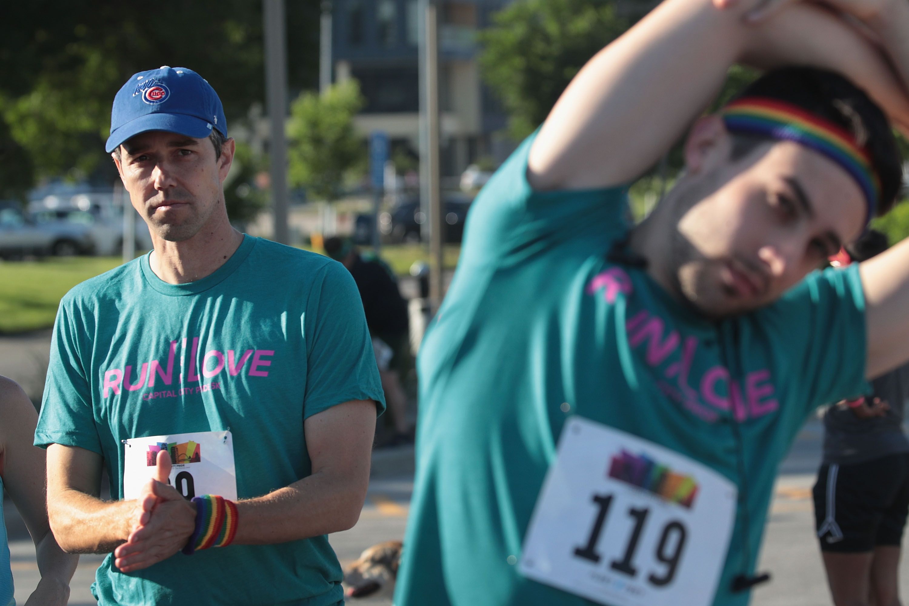  Democratic presidential candidate and former Texas congressman Beto O'Rourke (L) stretches before participating in the Pride Fest Fun Run 5K on June 08, 2019 in Des Moines, Iowa. 