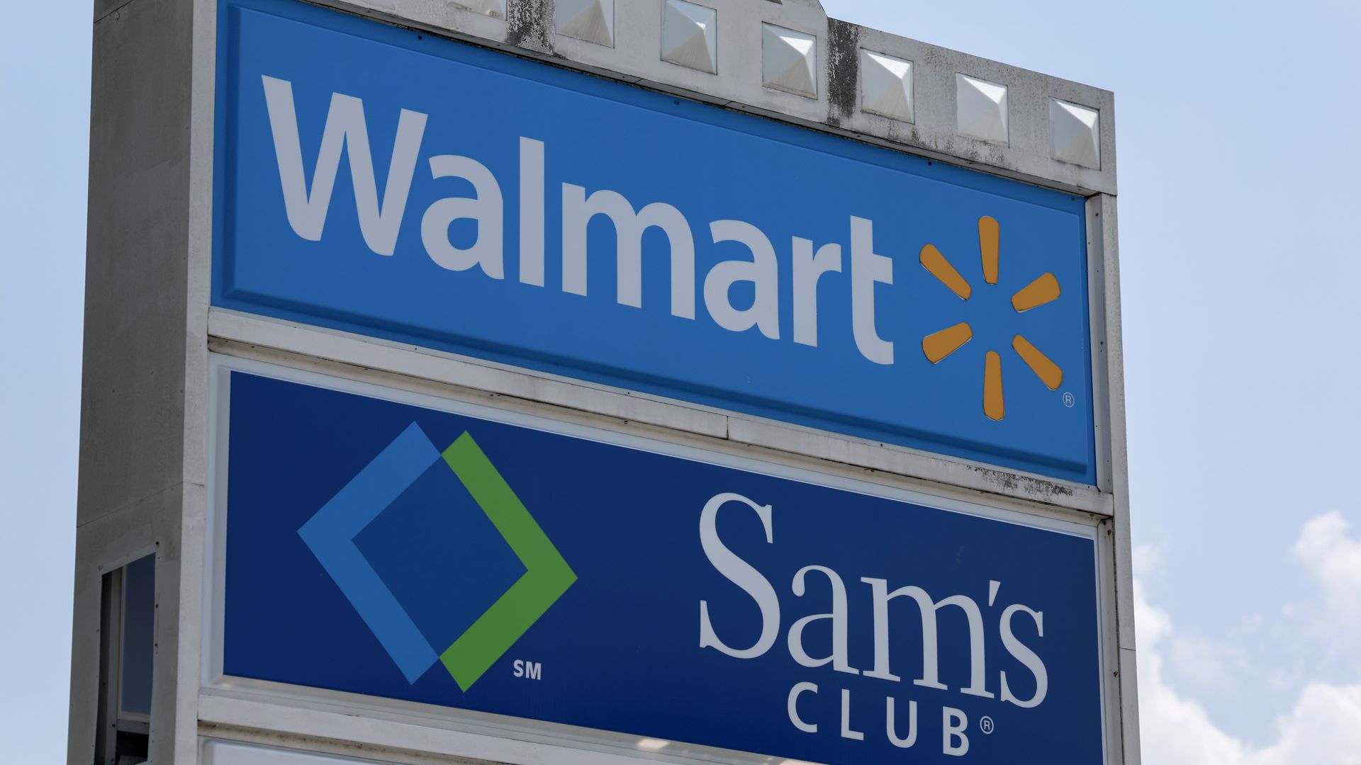 Sign that says Walmart with store logo with Sam's Club sign underneath