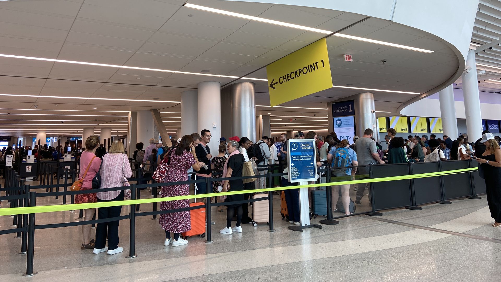 Charlotte airport passengers wait in line to get through security.