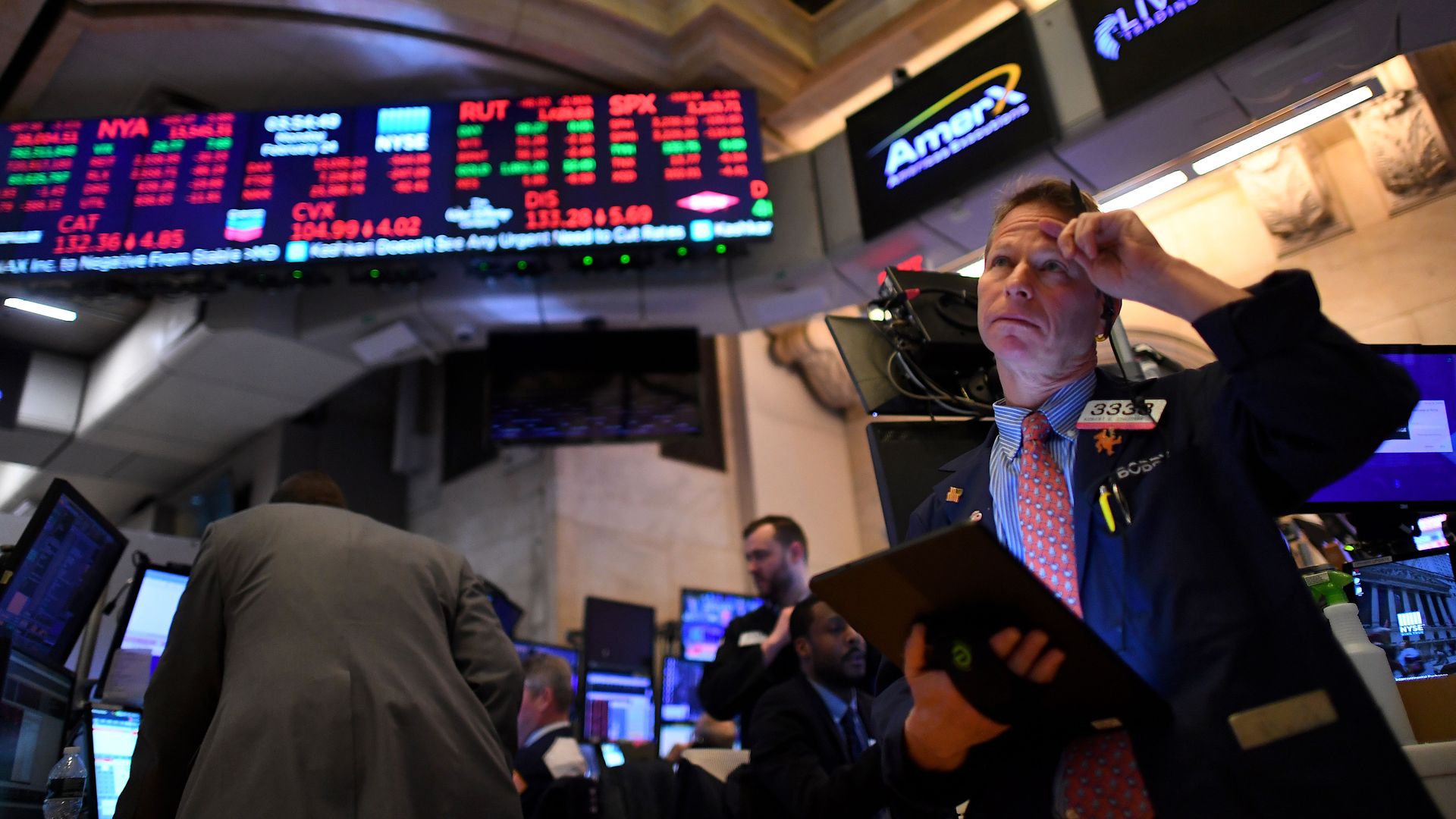 Trader in front of big boards at the New York Stock Exchange