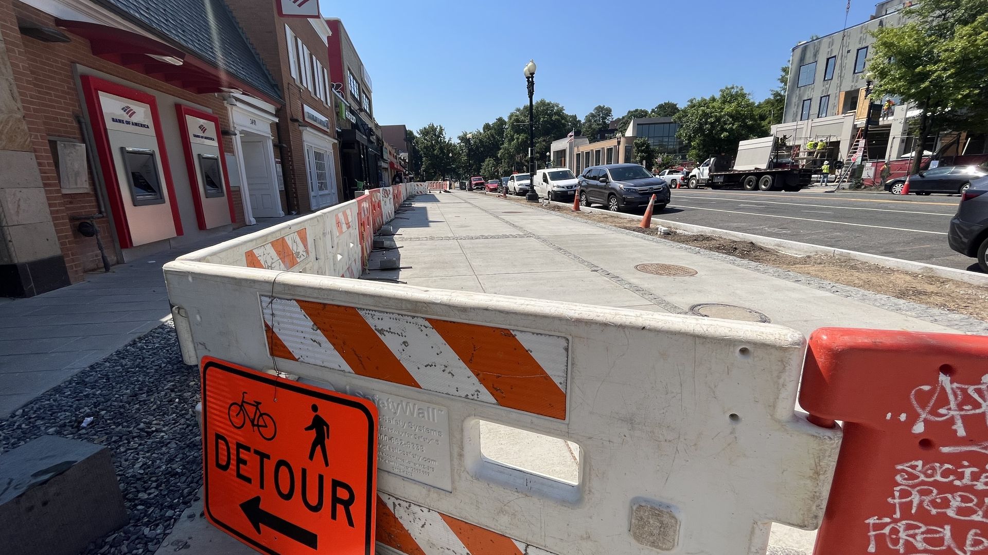 The renovated Cleveland Park service lane, with a "detour" sign and construction barricades 