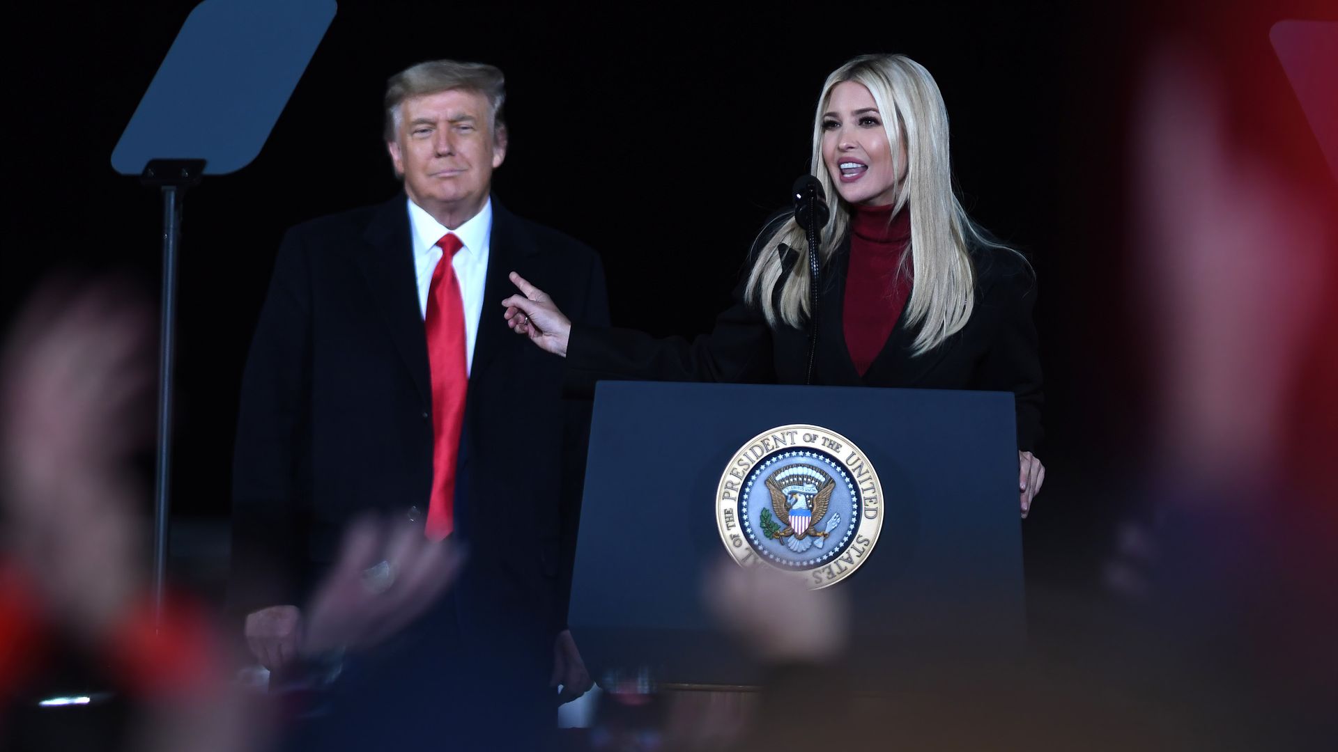 President Trump looks on as his daughter, Ivanka Trump, speaks at a Republican National Committee rally at the Dalton Regional Airport. 