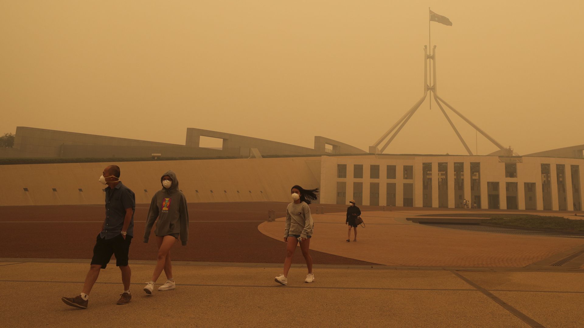 Visitors to Parliament House are forced to wear face masks after smoke from bushfires blankets Canberra in a haze with hazardous air quality on January 5, 2020 in Canberra, Australia