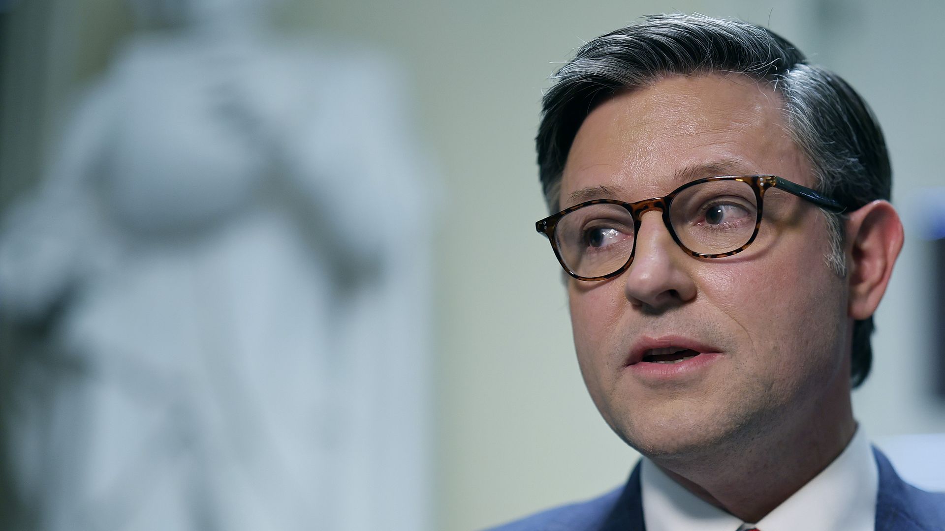 Mike Johnson looks to his right.