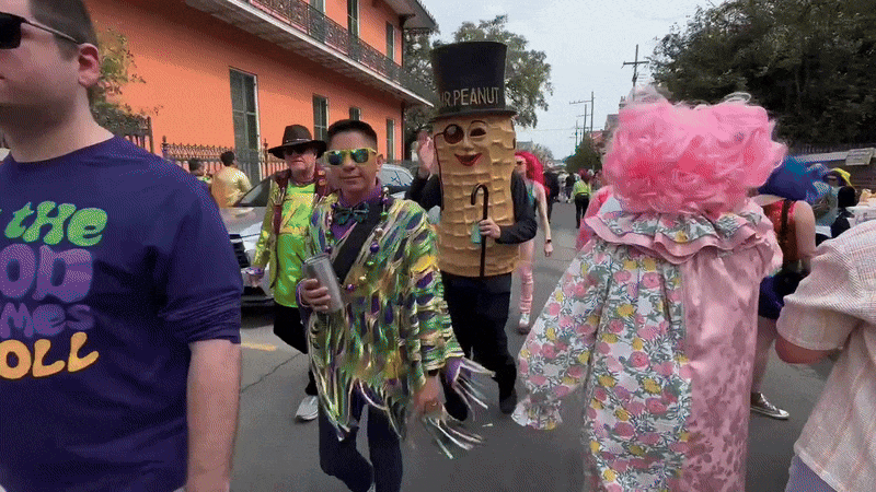 A person dressed as Mr. Peanut walks past the camera.