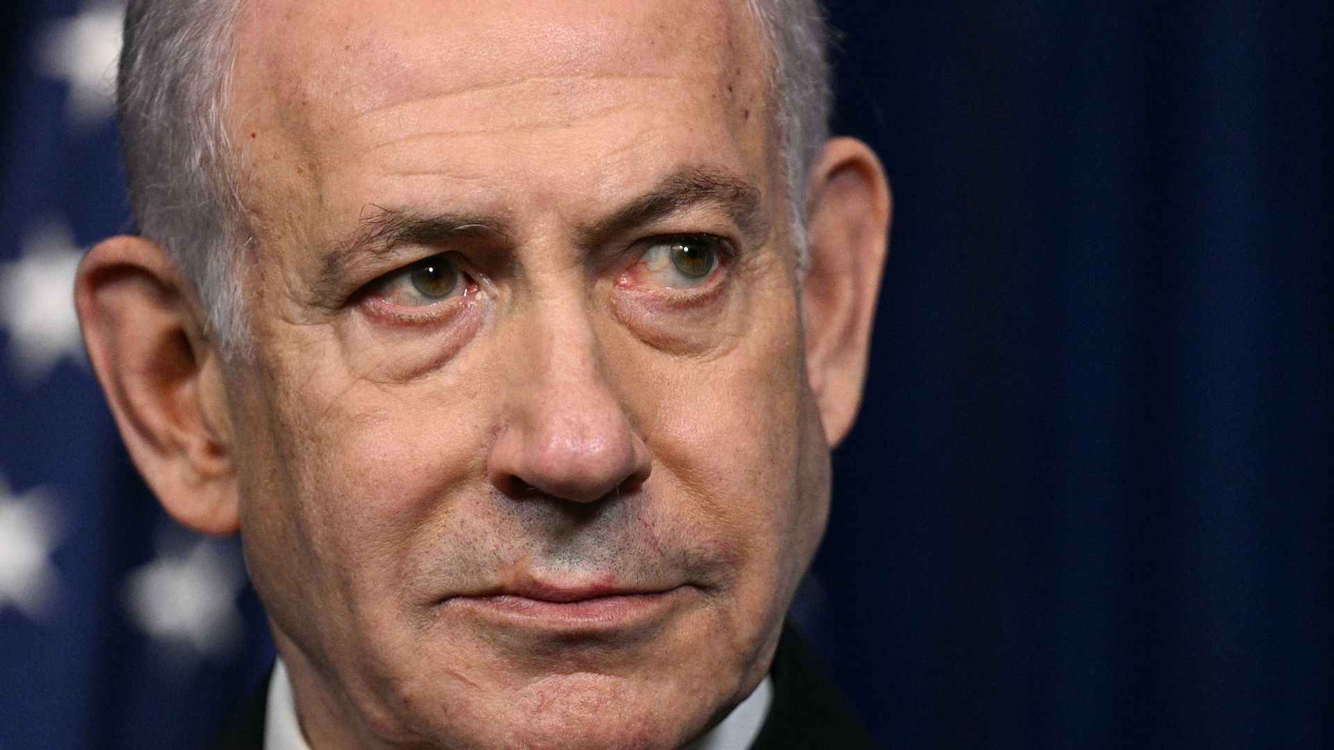 Israeli Prime Minister Benjamin Netanyahu looks on as President Trump (off frame) speaks during a joint press conference at Trump's Mar-a-Lago resort in December 2025. 