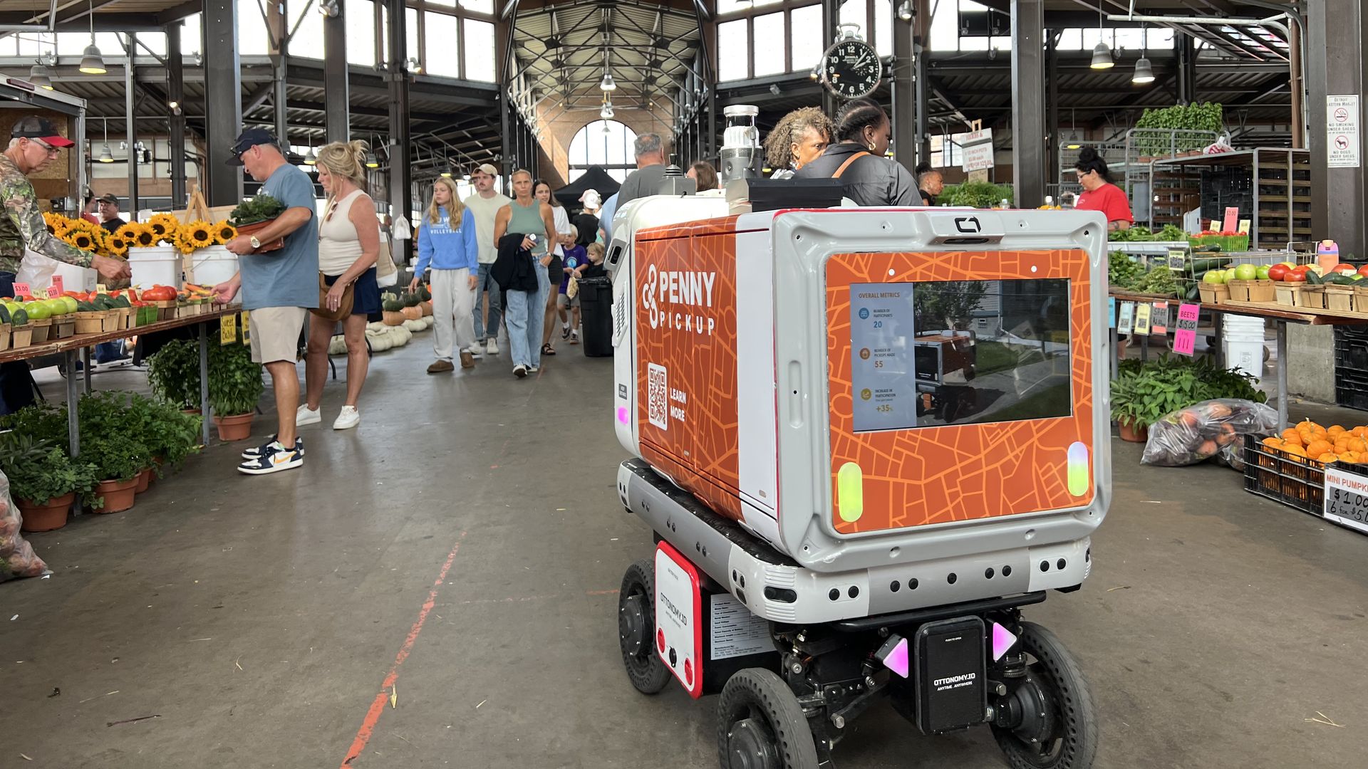 Penny Pickup, Orange Sparkle Ball's innovation that uses autonomous robots, in action at Detroit's Eastern Market.
