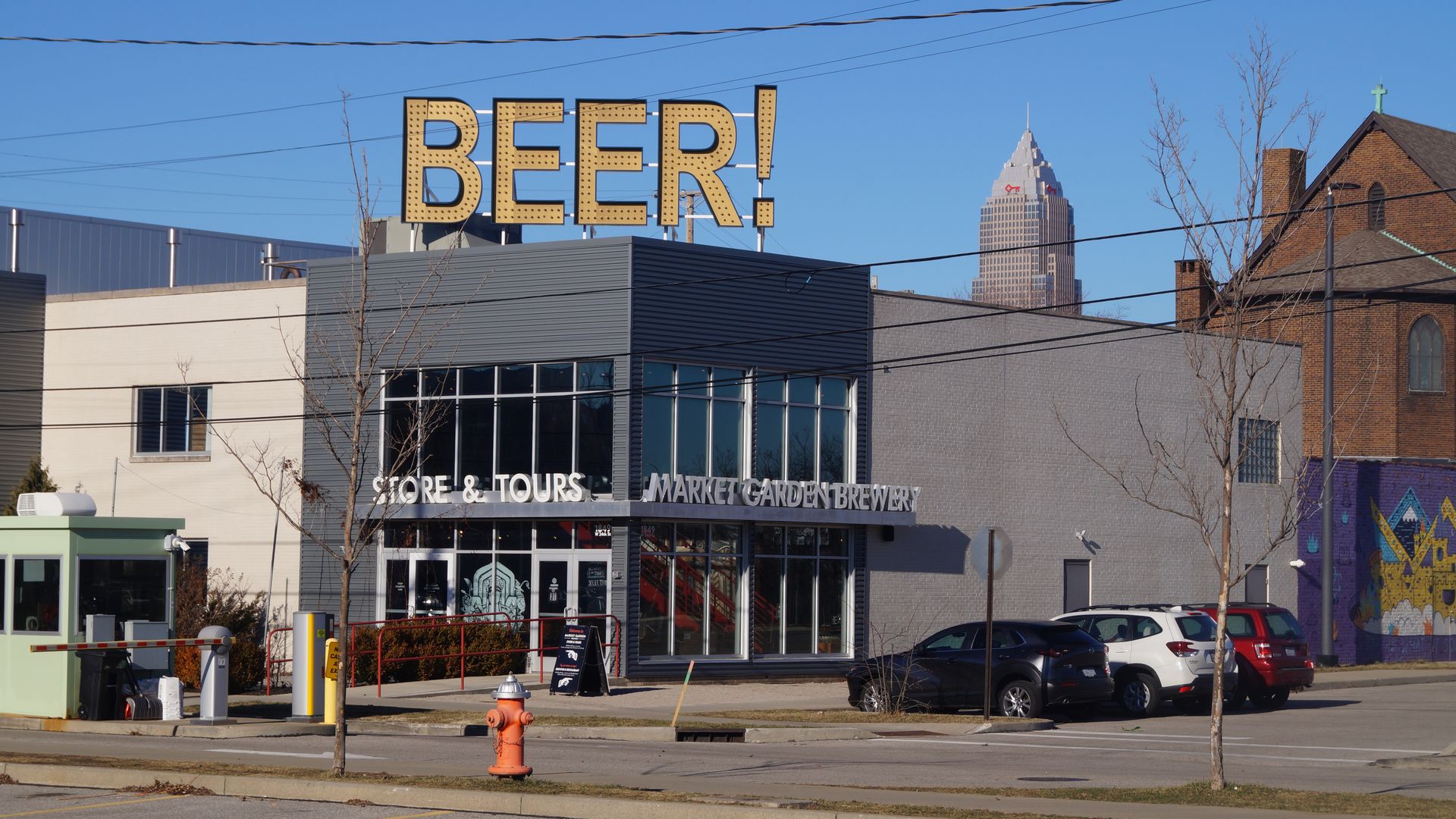 A sign reading "BEER" with Cleveland's Key Tower in the background