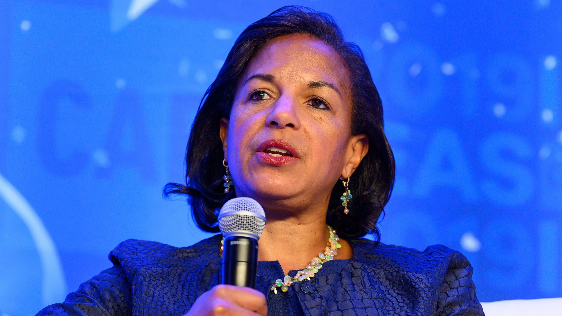 Ambassador Susan Rice holds a microphone as she speaks at an event