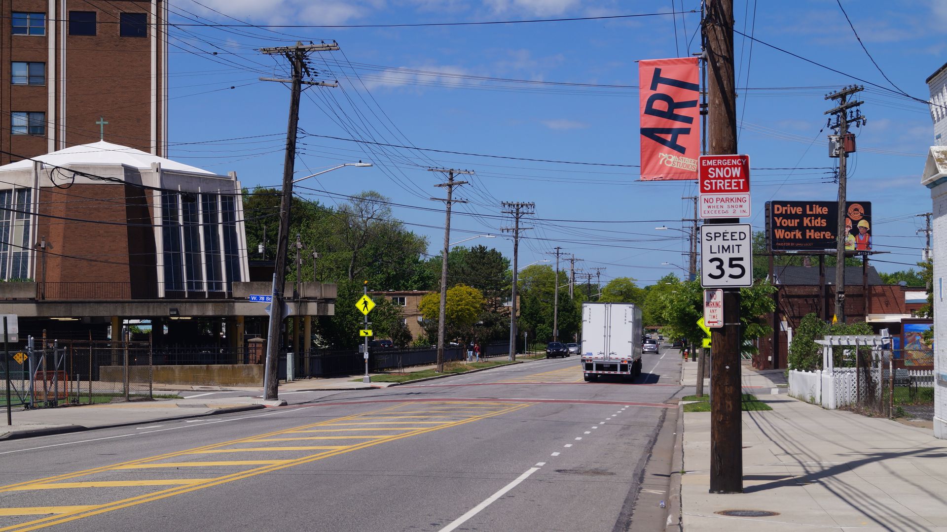 A picture of a city street with a SPEED LIMIT 35 sign on the right-hand sidewalk.