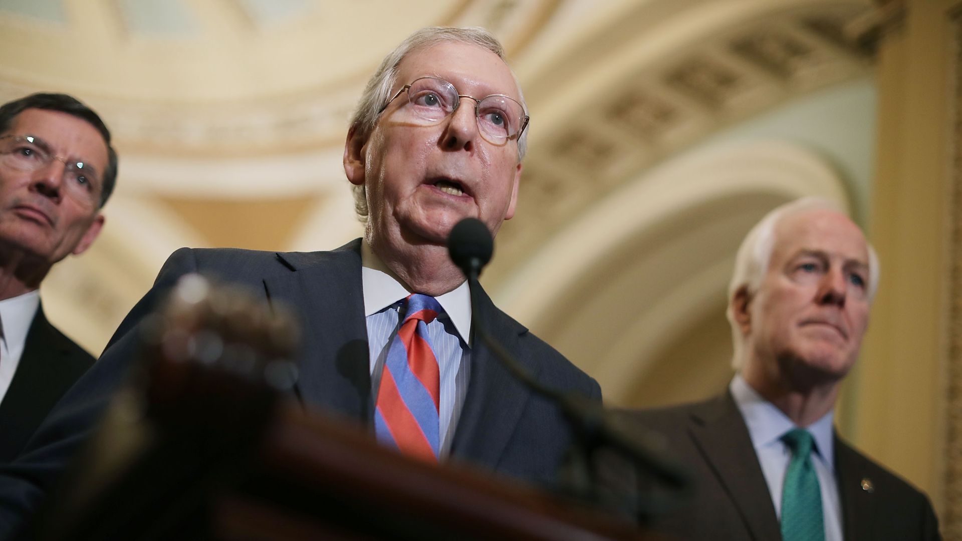 Senate Majority Leader Mitch McConnell (R-KY) talks to reporters at a podium in the Capitol 