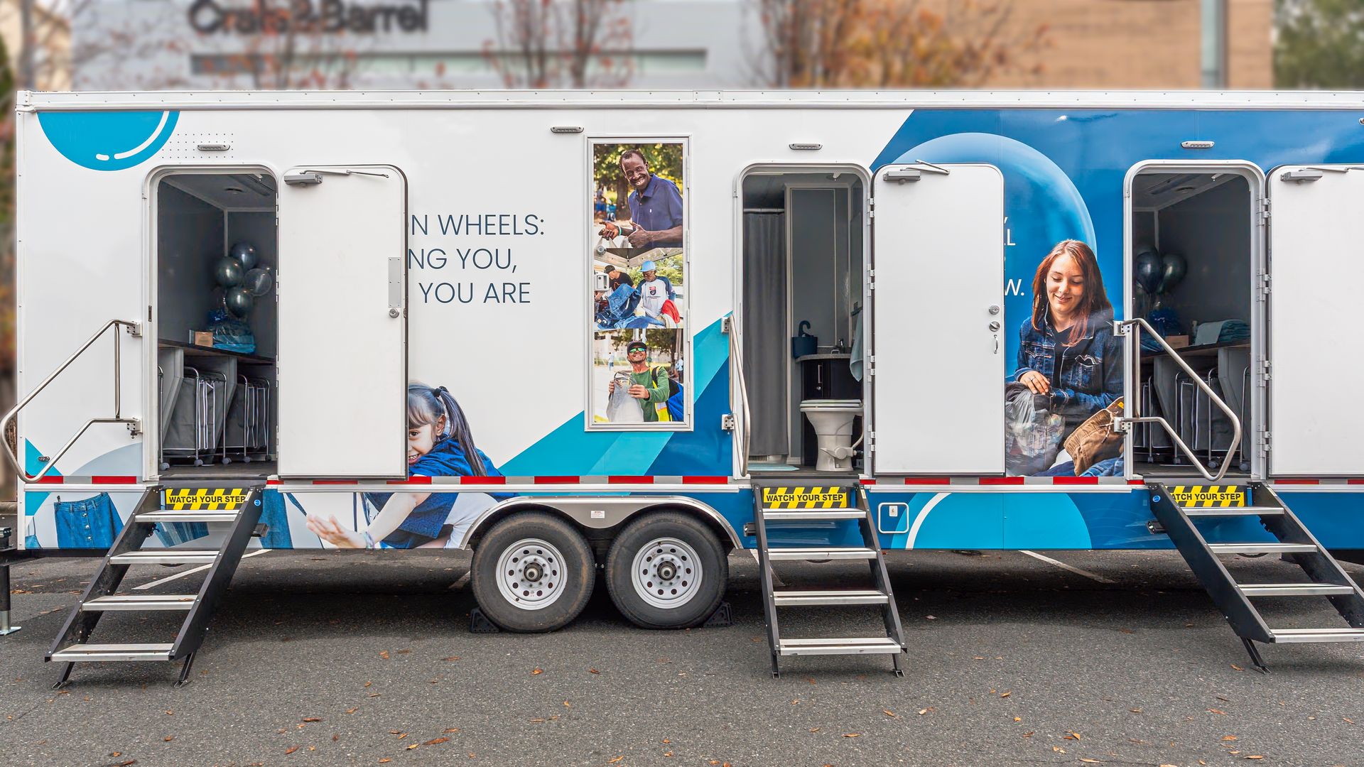 tailor with three doors opening to a shower and two laundry rooms