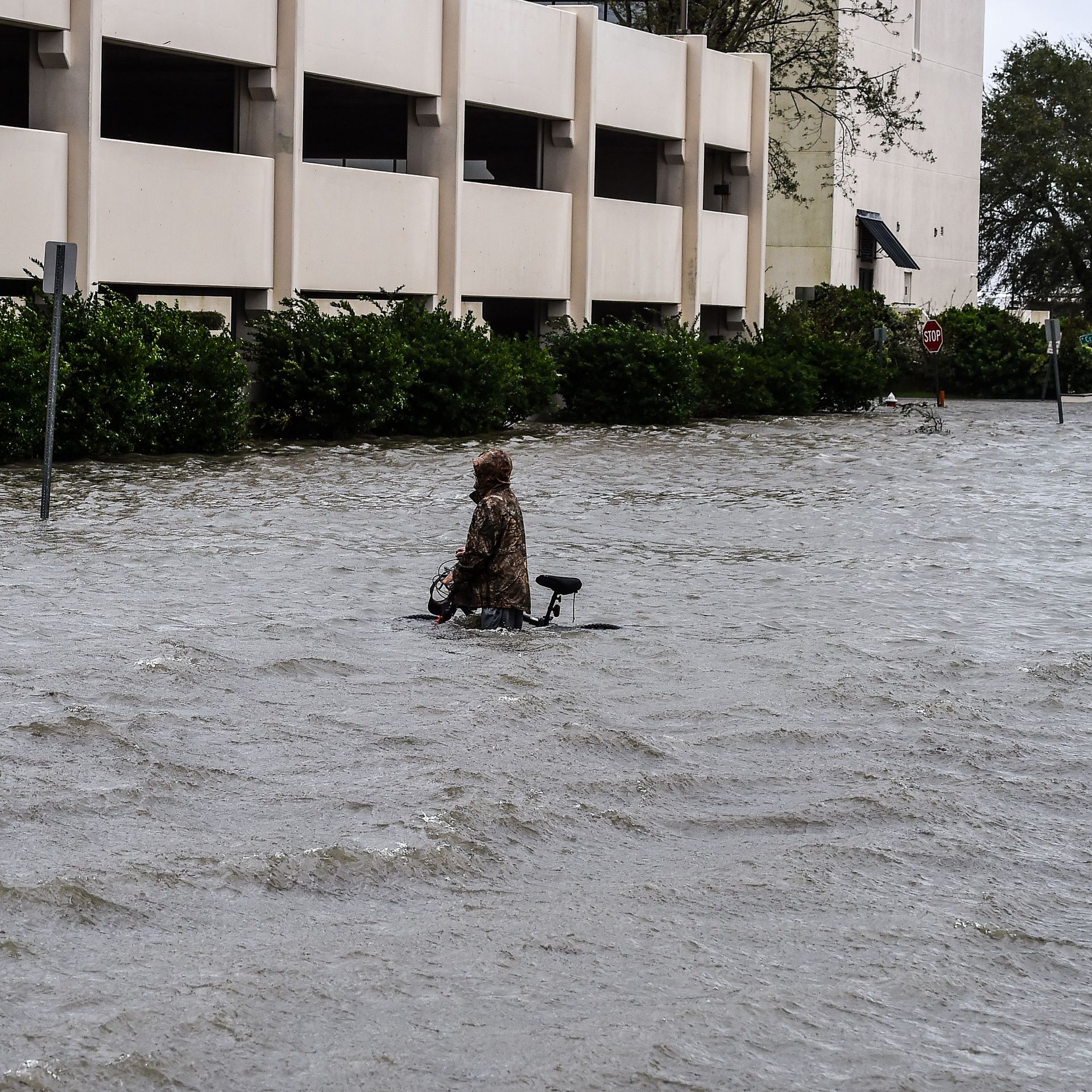 A man walks his bicycle through a street flooded by Hurricane Sally in Pensacola, Florida, on September 16