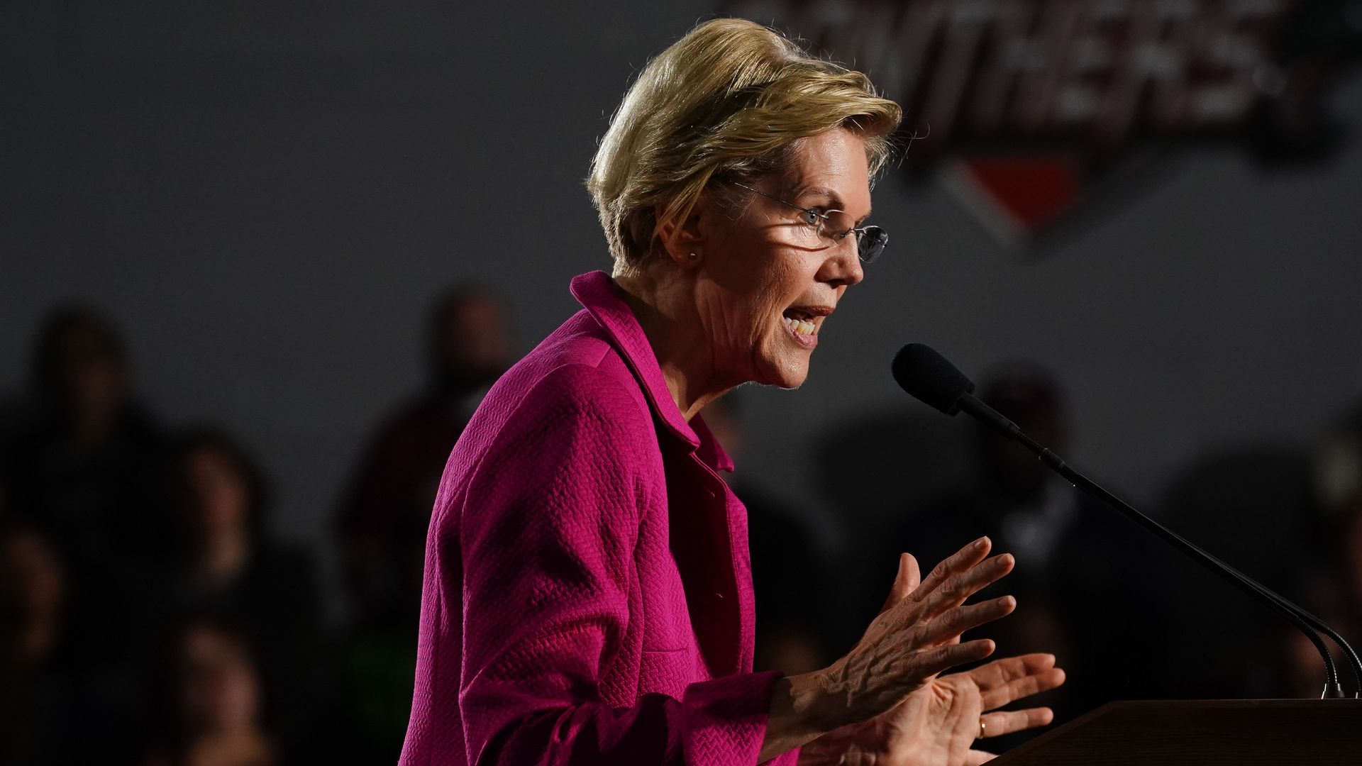 Warren speaking at a podium