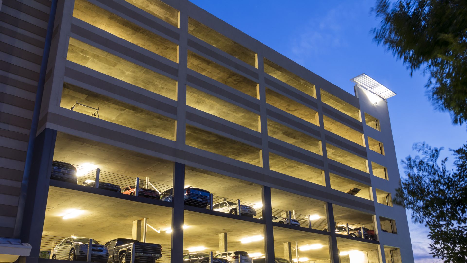 A full parking garage at night