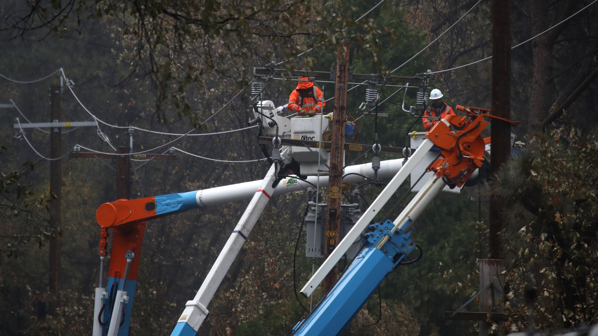 Pacific Gas and Electric (PG&E) crews repair power lines that were destroyed by the Camp Fire 