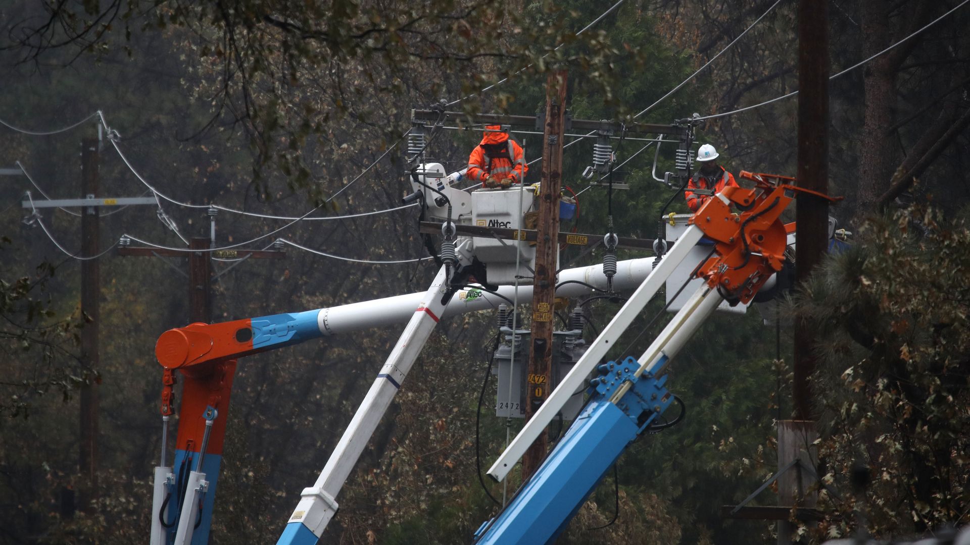 Pacific Gas and Electric (PG&E) crews repair power lines that were destroyed by the Camp Fire