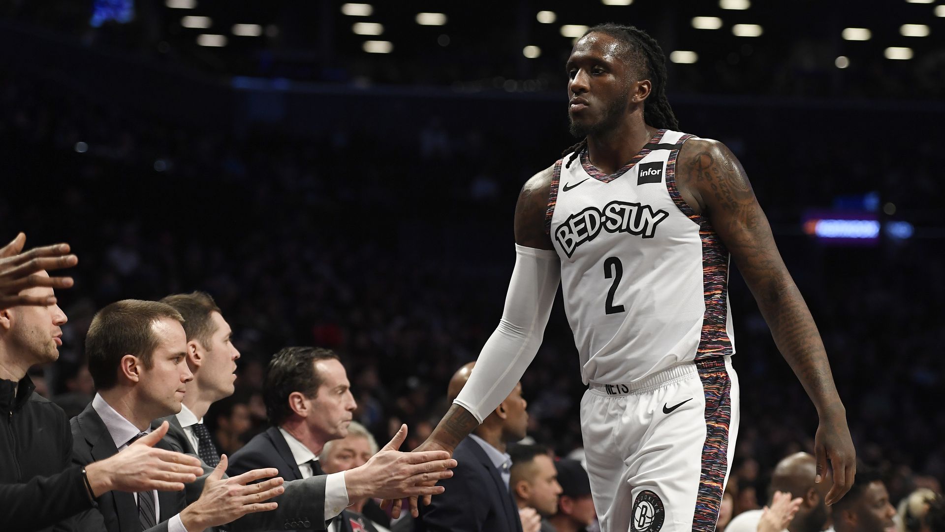 The Brooklyn Nets' Taurean Prince high-fiving coaches in a game against the Miami Heat 