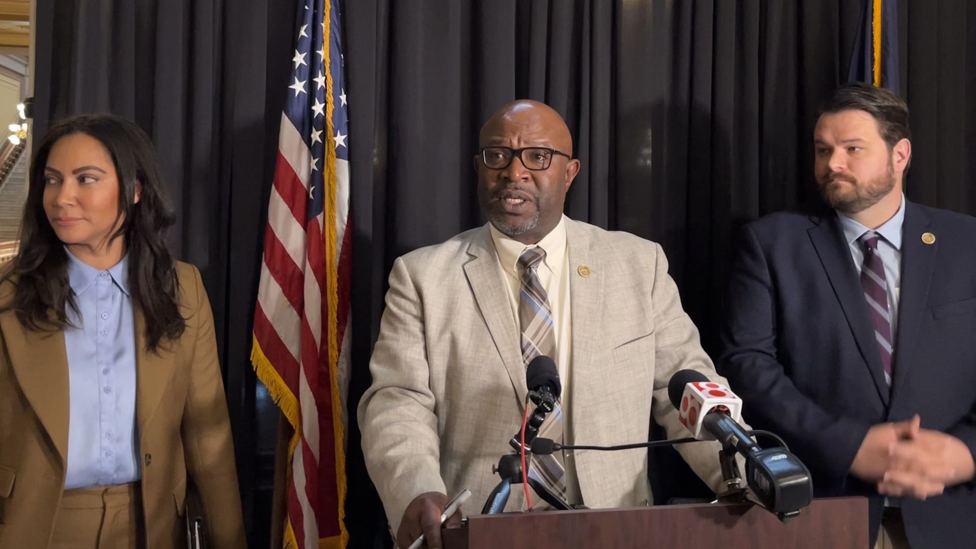 Three people in front of a podium