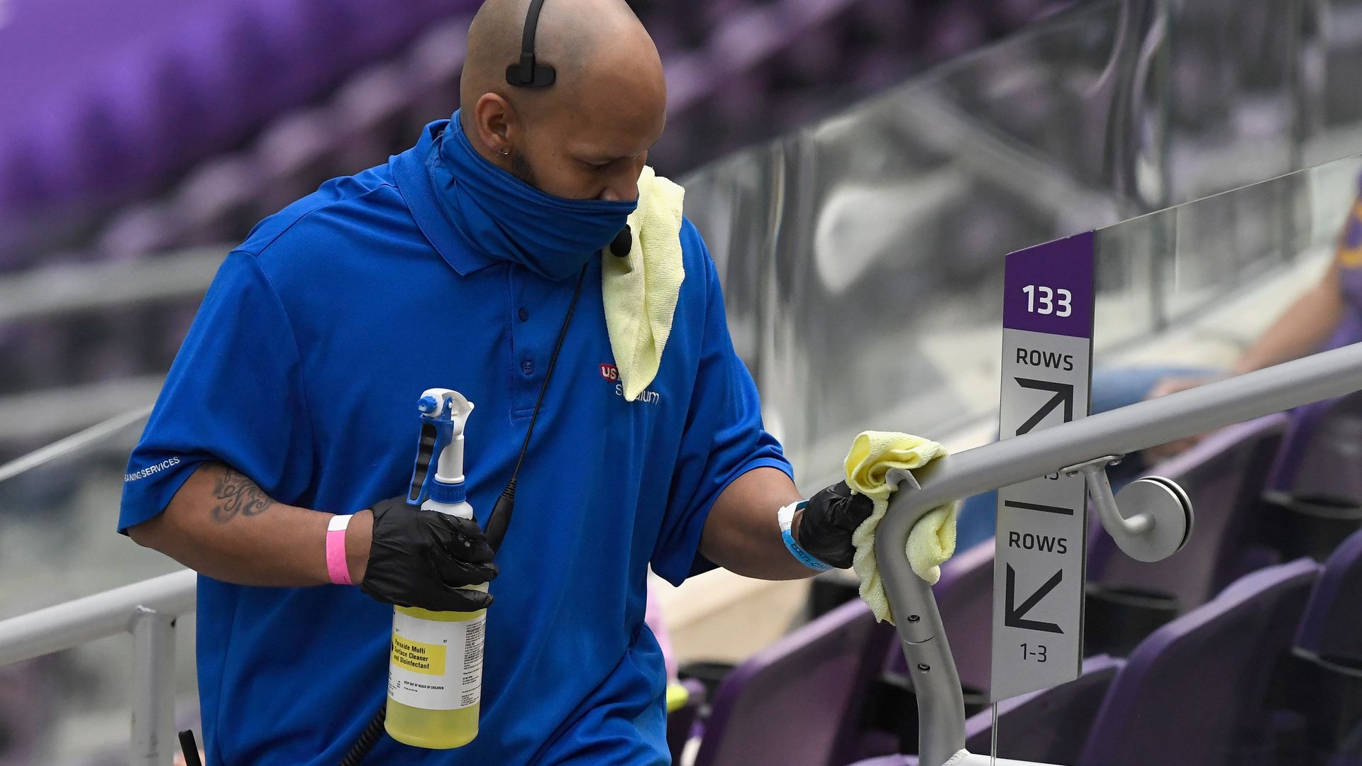 A worker cleans a handrail at a Tennessee Titans game. 