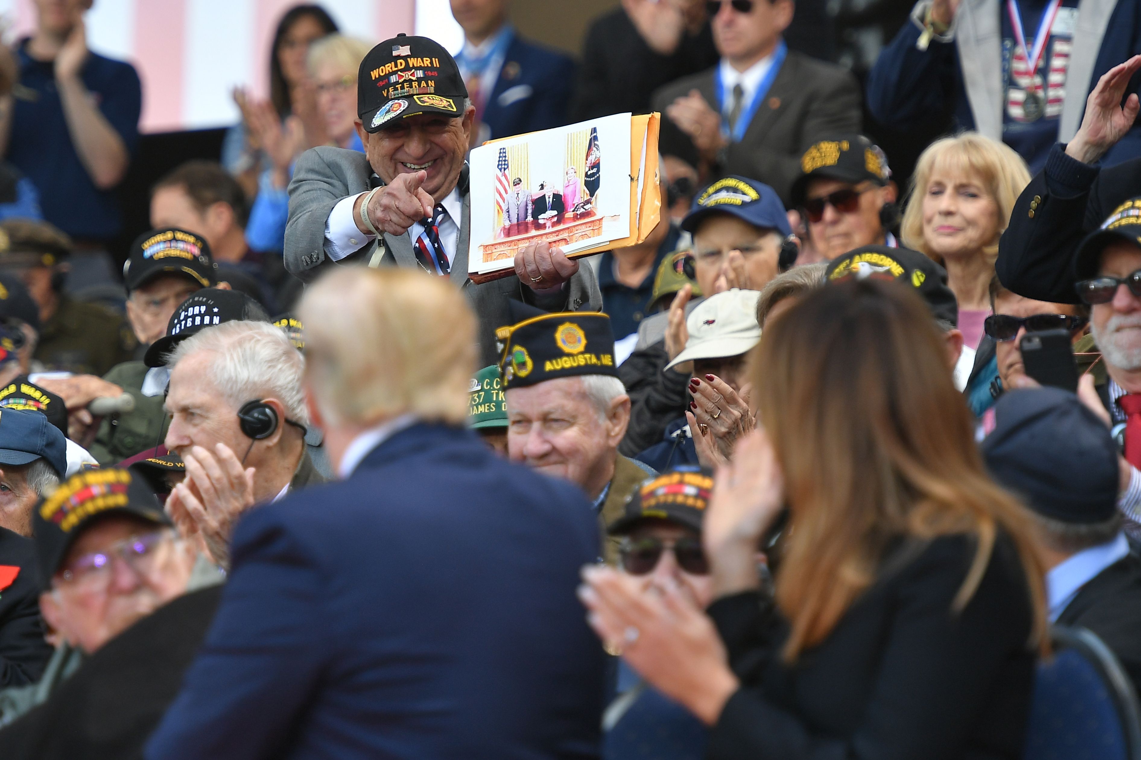 A WWII veteran points to US President Donald Trump and US First Lady Melania Trump during a French-US ceremony at the Normandy American Cemetery and Memorial in Colleville-sur-Mer.