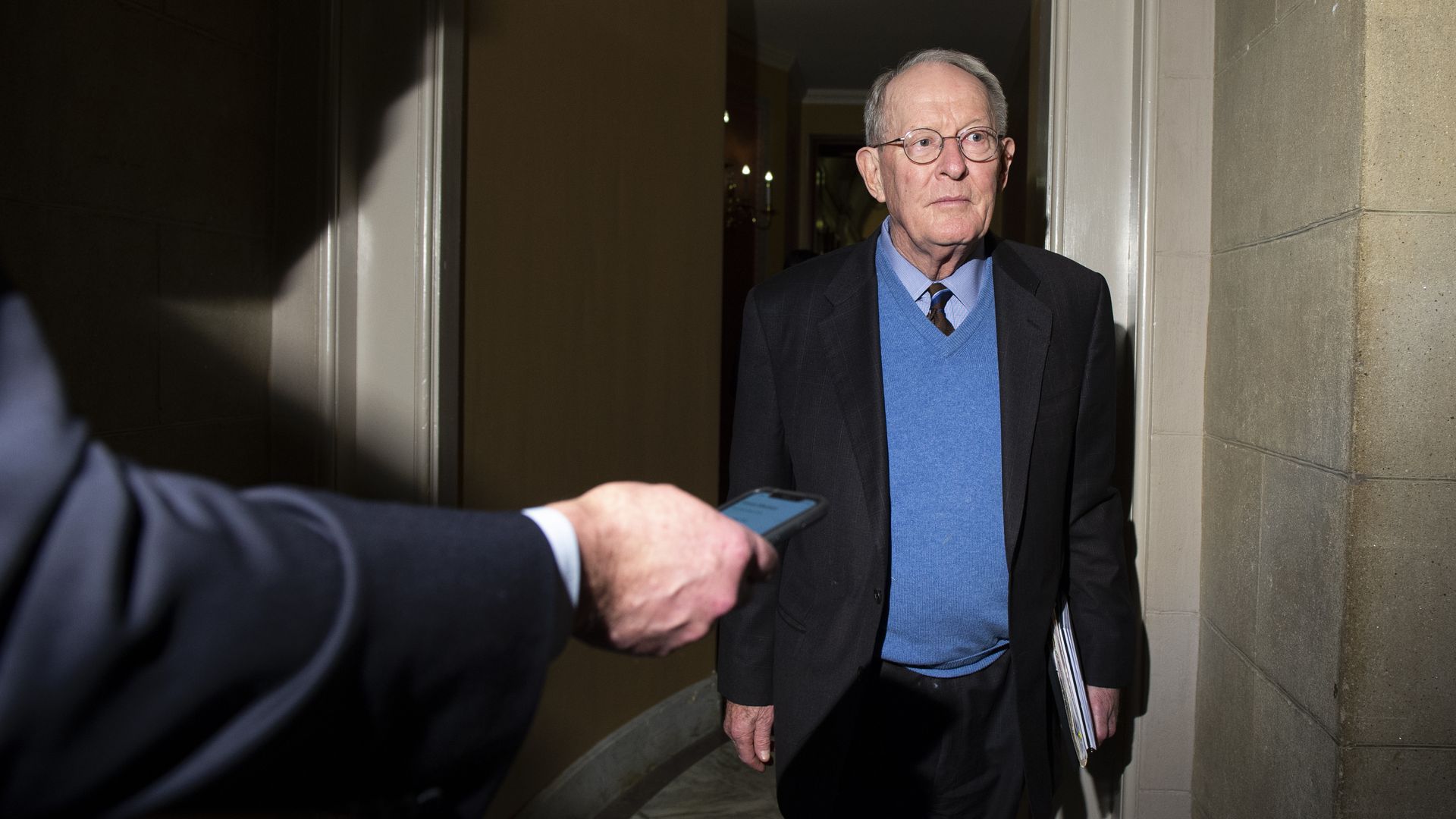 Sen. Lamar Alexander, R-Tenn., speaks with reporters as he leaves the Capitol.