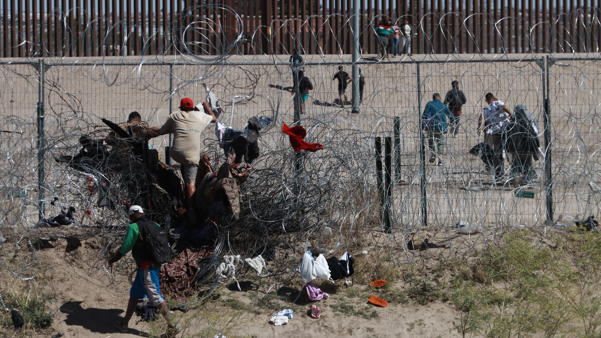 Migrants arrive to the border after crossing the Rio Grande and crossing the new fence, cutting it with pliers, installed by the Texas National Guard Ciudad Juarez, Mexico on March 12, 2024. (Photo by Christian Torres/Anadolu via Getty Images)
