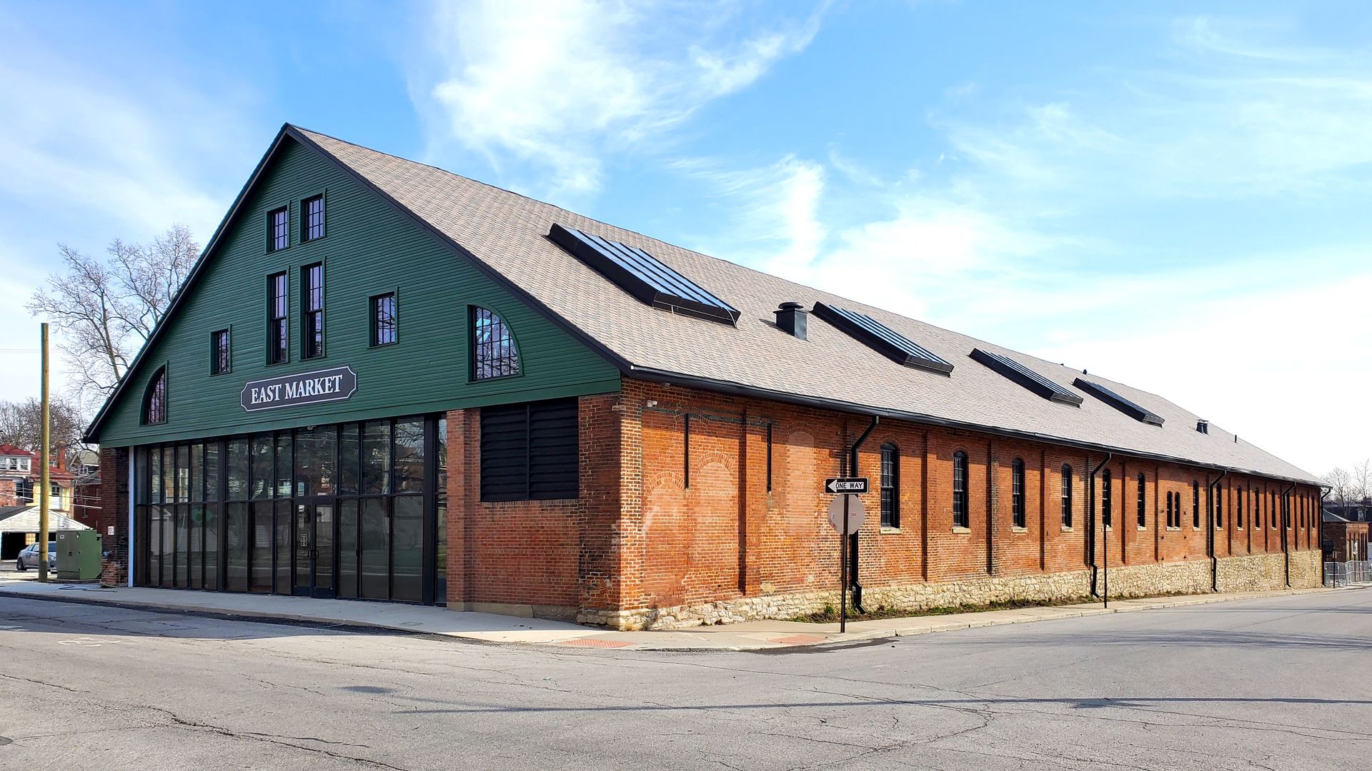 The Oak Street side of East Market, a brick building with a green painted facade