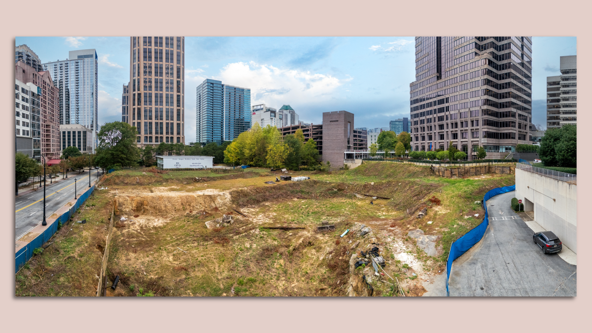 A vacant four-acre piece of land surrounded by tall towers in an urban environment