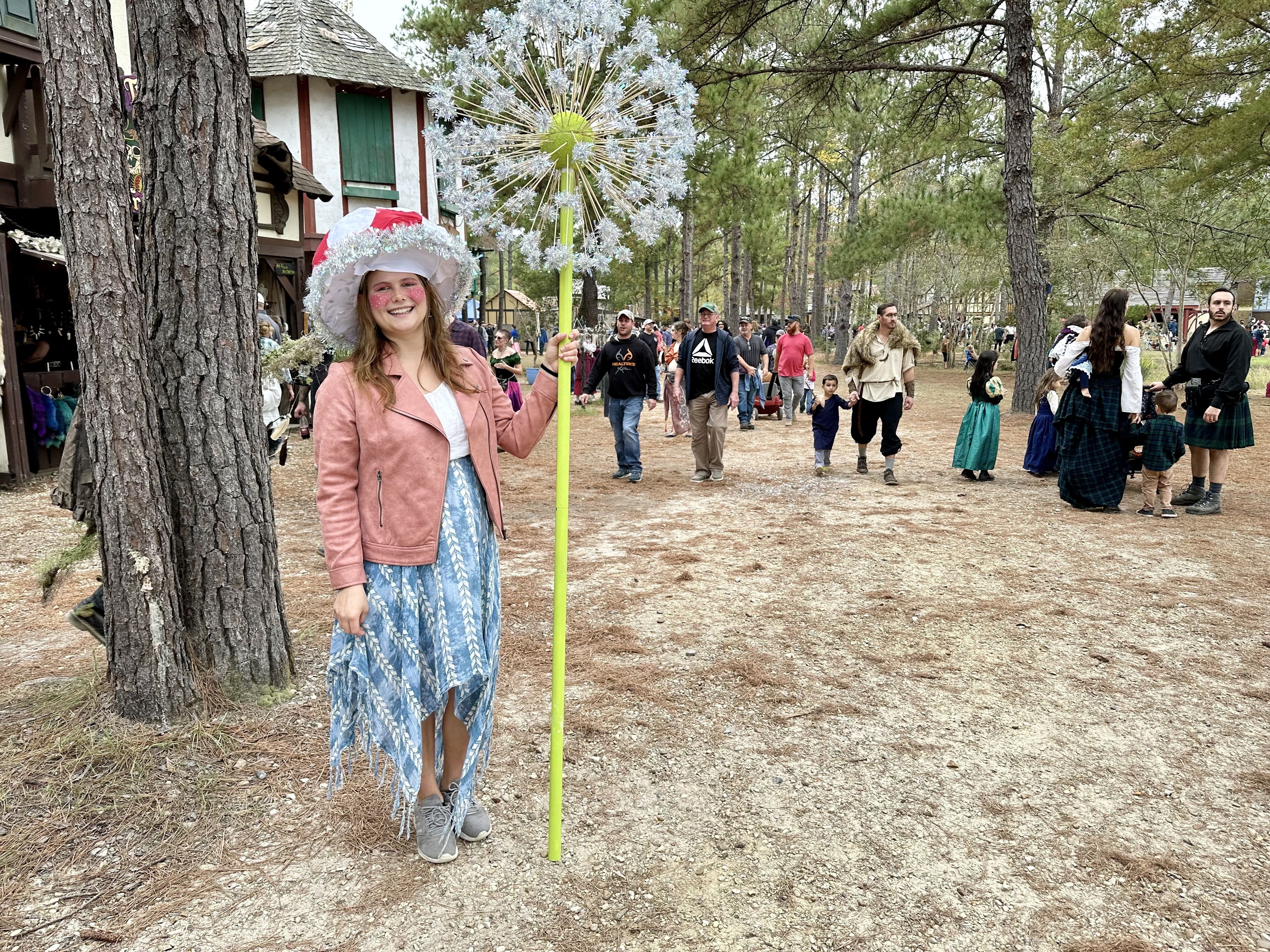 Photo shows a woman dressed up with a dandelion.