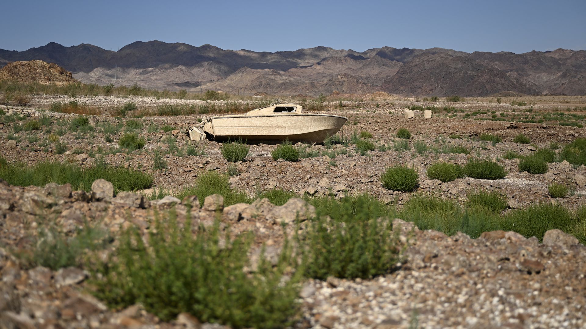  A sunken boat emerges on the shore at Lake Mead after water levels drop due to prolonged drought on August 18, 2022 near Boulder City, Nevada. 