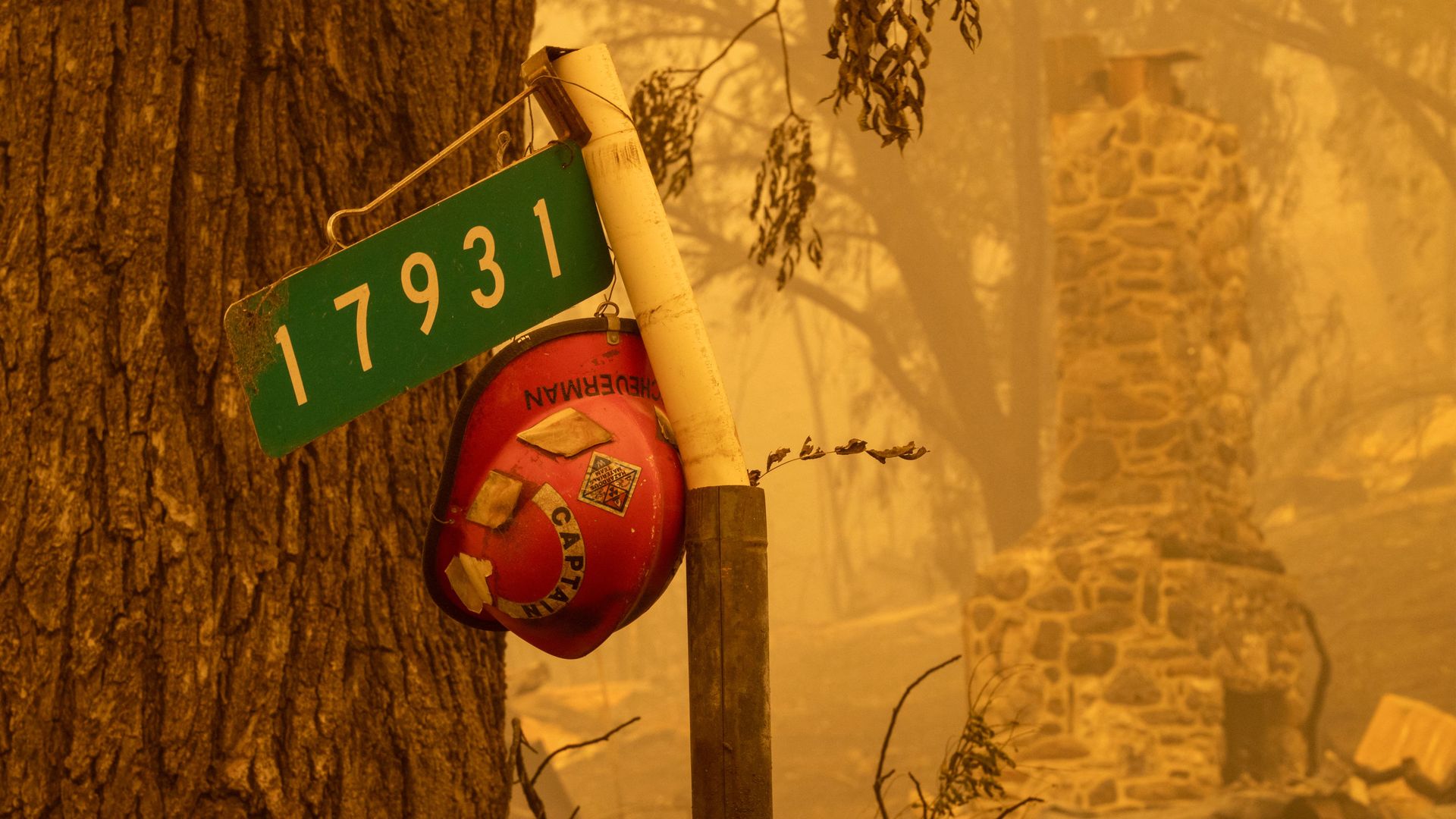 A firefighter helmet hangs at the entrance to a property in the community of Klamath River, which burned in the McKinney Fire, in Klamath National Forest, northwest of Yreka, California, on July 31.
