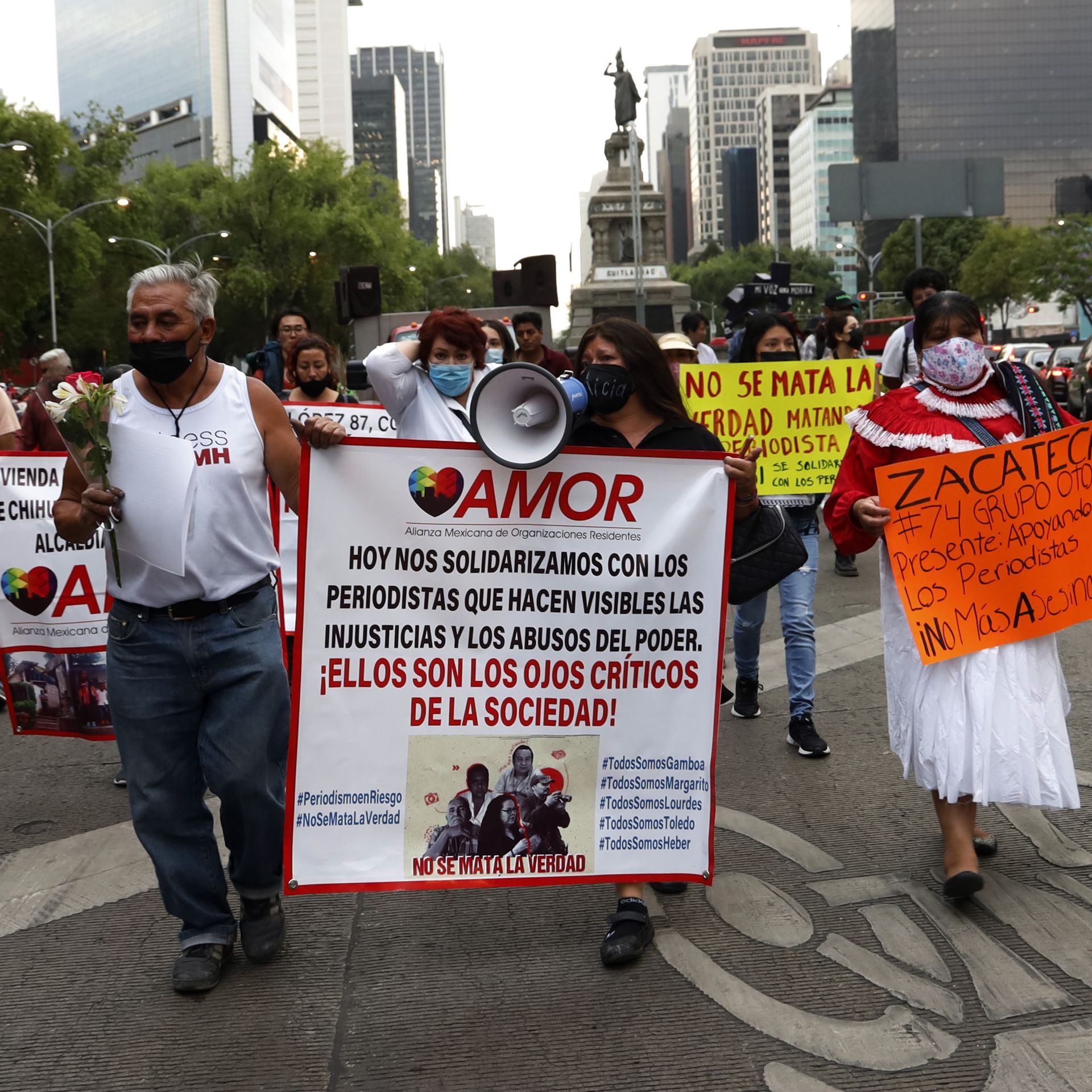 Protesters carrying signs and banners march for journalists' safety in Mexico City 