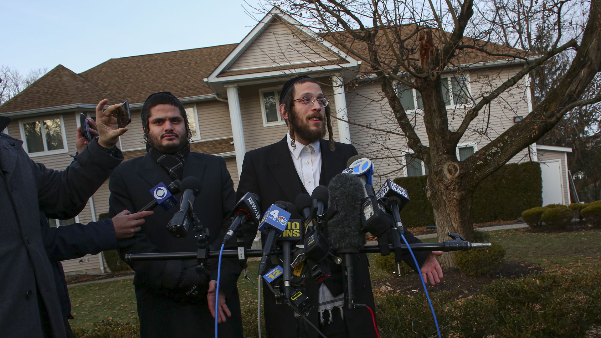Orthodox Jew speaking outside of rabbi's home