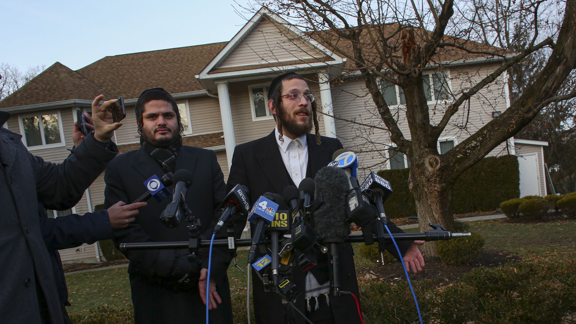Orthodox Jew speaking outside of rabbi's home