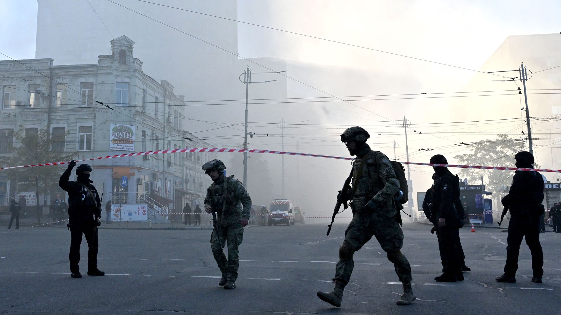 Ukrainian soldiers and police officers in Kyiv after a Russian drone attack against the city on Oct. 17.