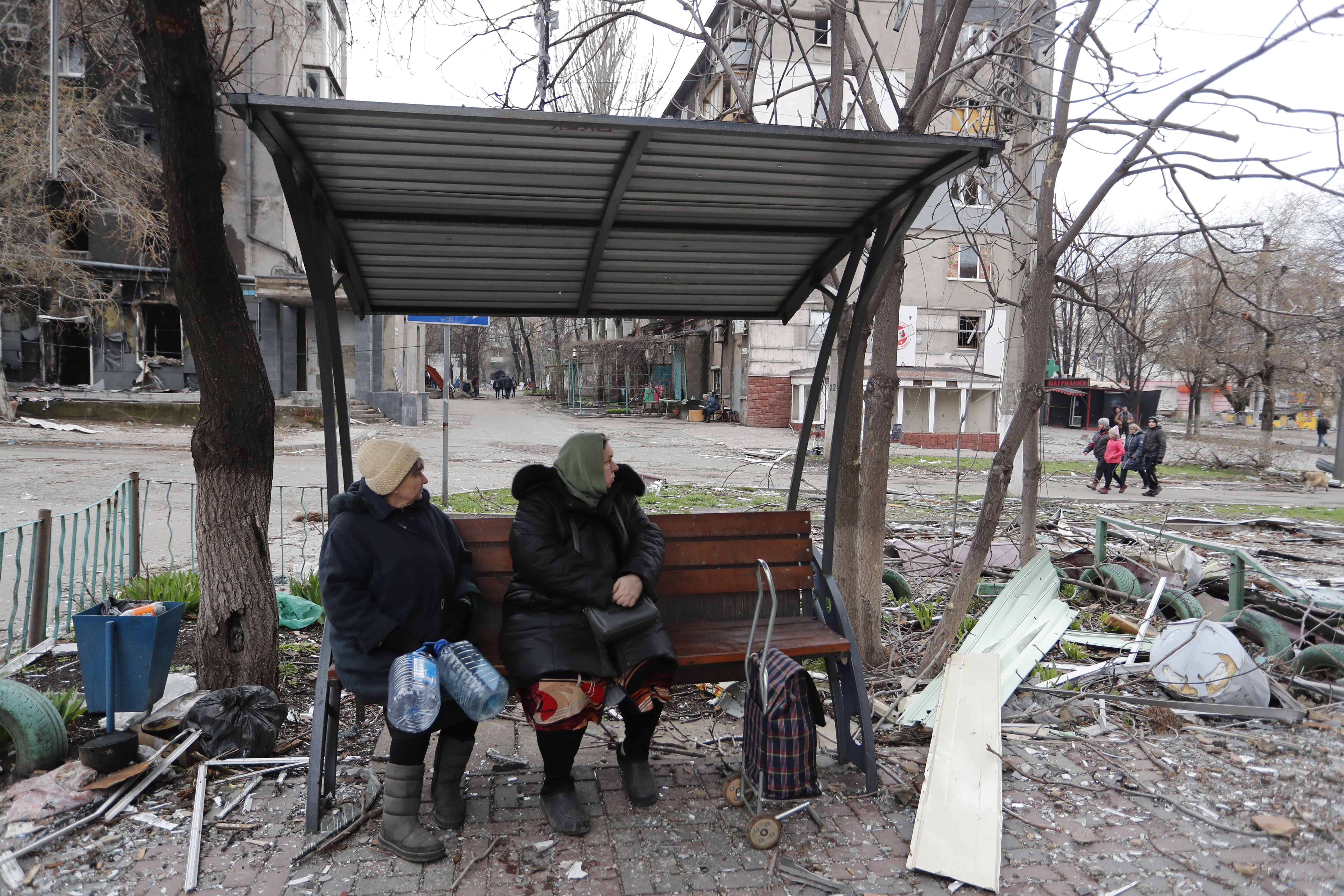  People sit outdoors in Mariupol, April 14.