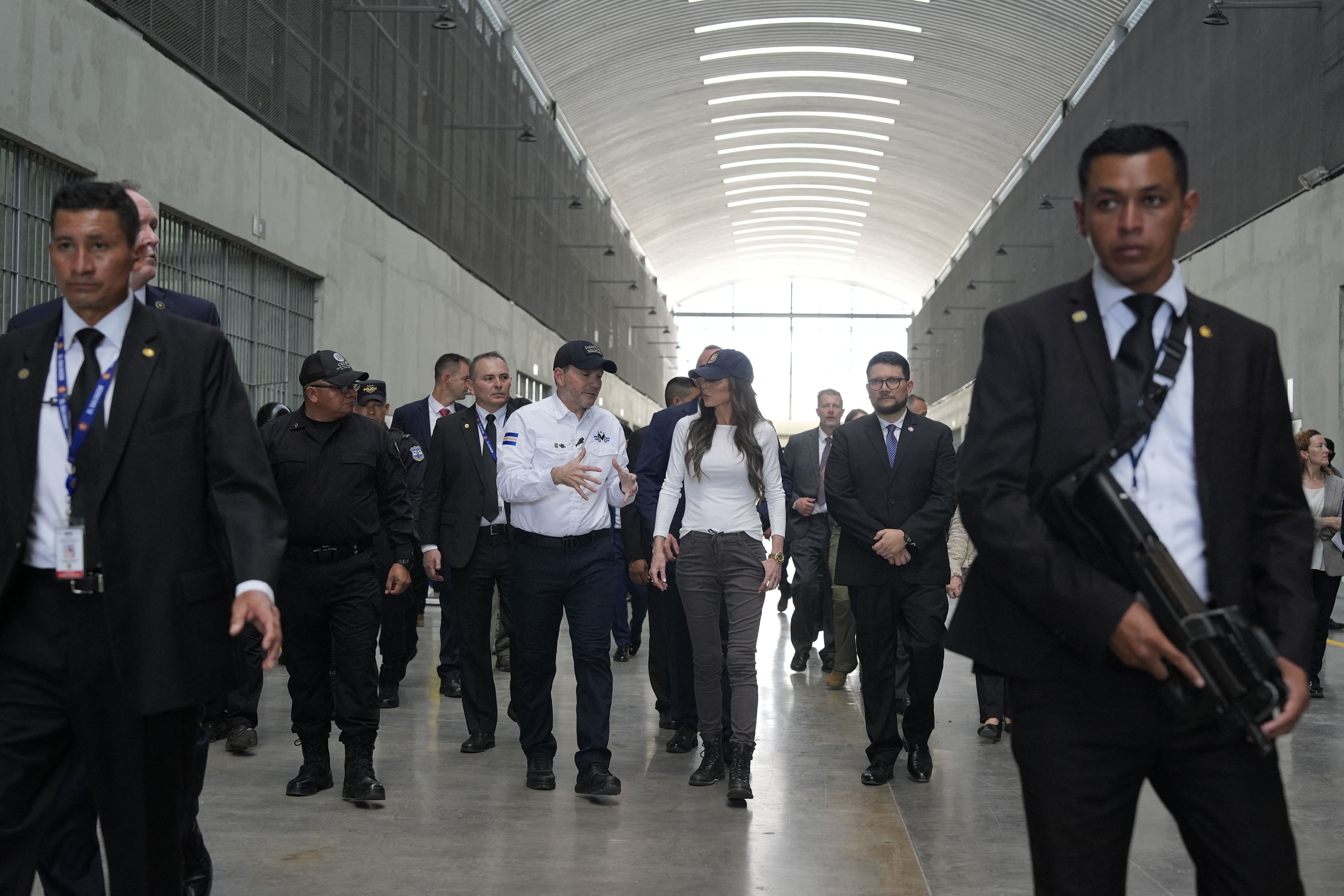  El Salvador's Minister of Justice and Public Security Gustavo Villatoro (C-L) accompanies US Homeland Security Secretary Kristi Noem during a tour of cellblock 7 of the Terrorist Confinement Center (CECOT) in Tecoluca, El Salvador, March 26, 2025. 