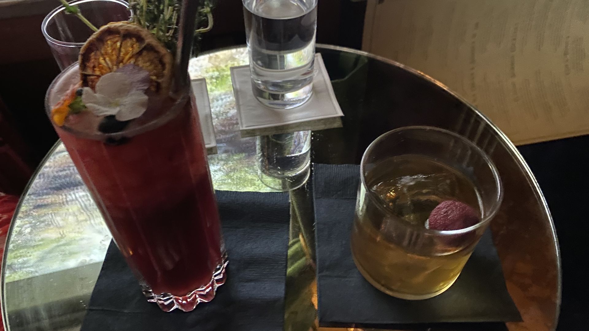 Two cocktails on a small circular table