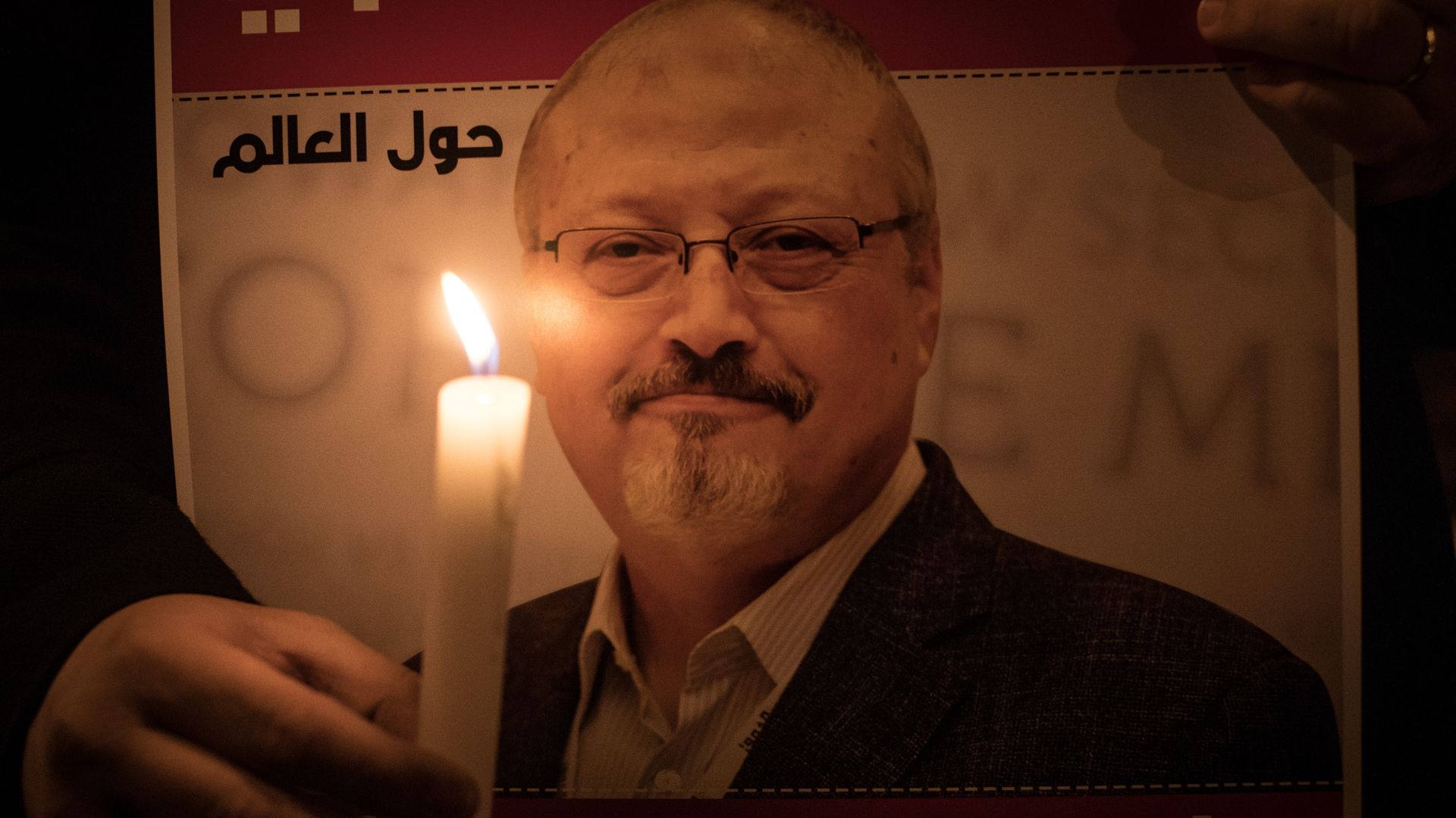 People take part in a candle light vigil to remember journalist Jamal Khashoggi.
