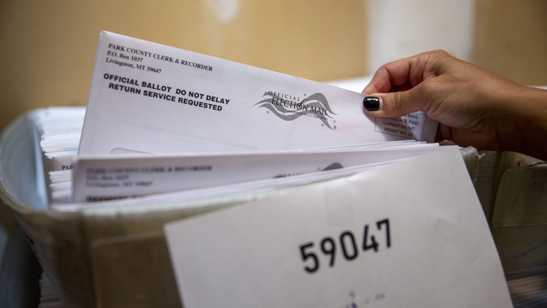 Photo of a ballot in an envelope in a box