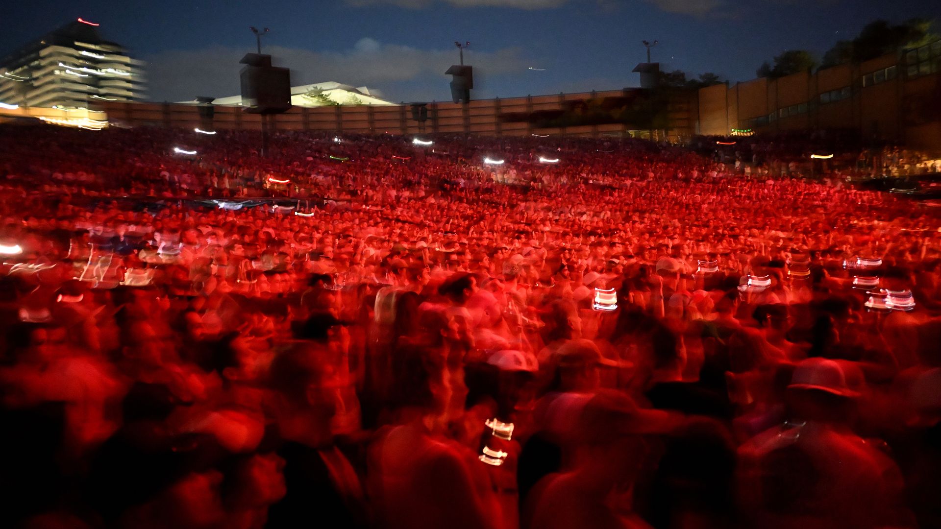 A blurry photo of a crowd at an outdoor concert.