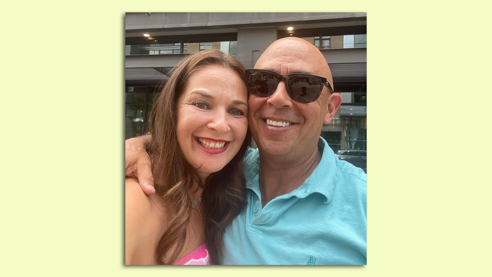 A photo of Karina and Ari standing together and smiling while taking a selfie