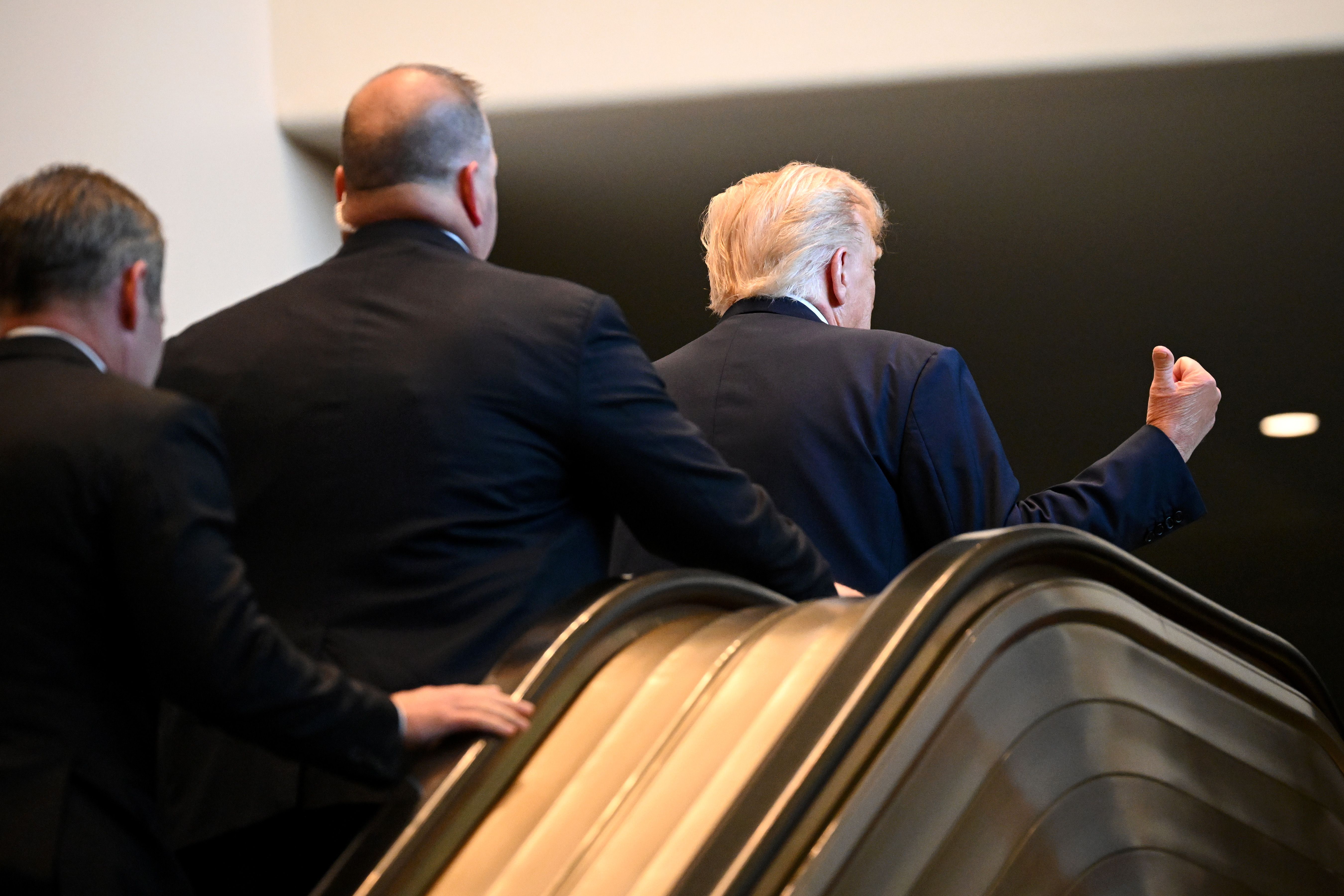 President Trump gestures after walking up an escalator as he arrives at the UN General Assembly.