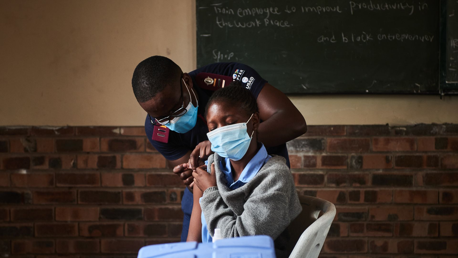A young student in South Africa receiving a COVID vaccination.