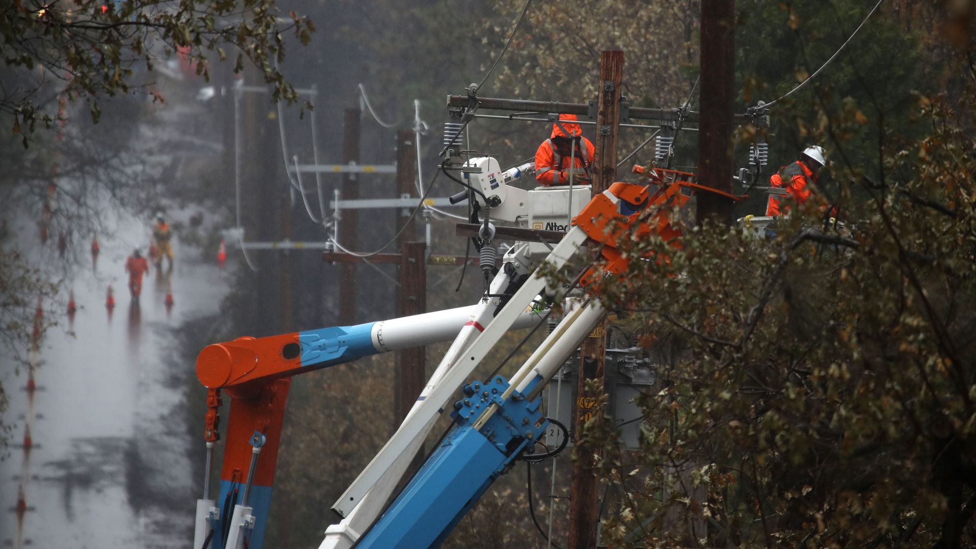 Pacific Gas and Electric (PG&E) crews repair power lines that were destroyed by the Camp Fire on November 21, 2018 in Paradise, California.